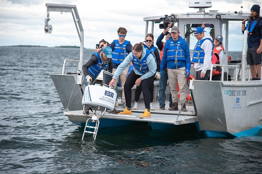 UNE students deploy a shark detection buoy from the RV Sakohki into Saco Bay
