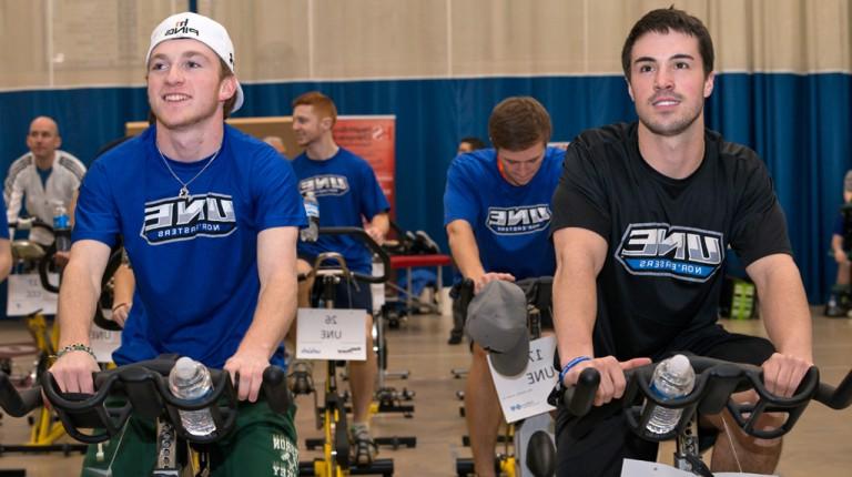 Several students cycling on stationary bikes during an event in Finley Recreation Center