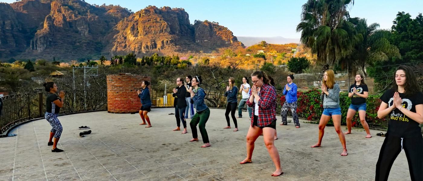 UNE students doing yoga in Mexico