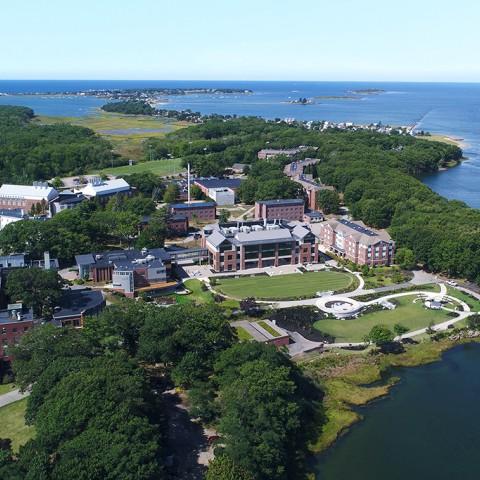 An aerial view of the Biddeford Campus near the river and ocean